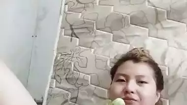 Nepali girl masturbating using big cucumber